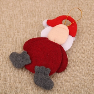 Macro shot of minimalist felt Santa ornament with golden string on a rustic jute texture