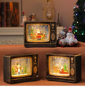 Detail of vintage Christmas TV water lantern with warm LED lights and swirling glitter