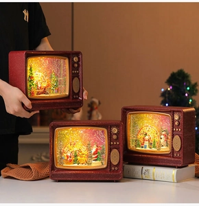 Close-up of vintage red TV ornaments with LED lights and miniature Christmas scenes