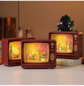 Detail of vintage TV Christmas snow globe with glowing LED light and moving glitter scenes