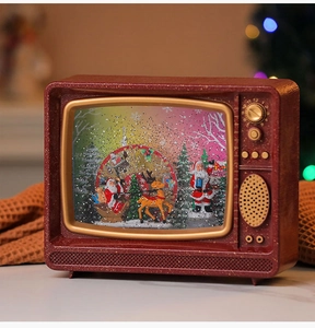Detail of vintage Christmas TV snow globe with Santa Claus, glowing lights and music
