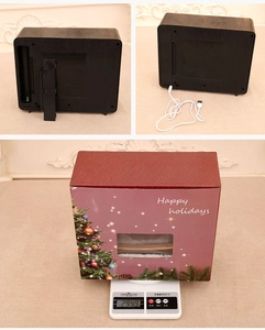 Rear view of Christmas TV ornament showing battery compartment and USB charging cable