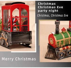 Close-up of vintage red Christmas train ornament with Santa, reindeer and snowy glitter