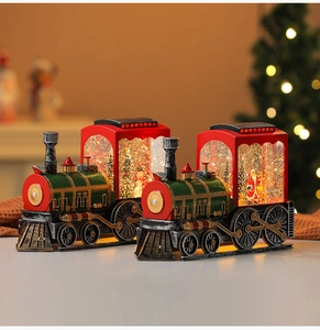 Close-up of vintage Christmas train snow globe lights with Santa and tree inside