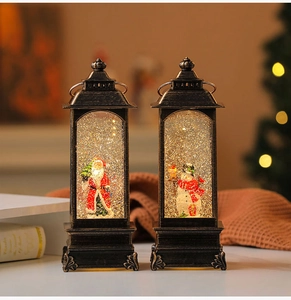 Detail of vintage Christmas lanterns with Santa and Snowman motifs in swirling gold glitter