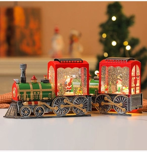 Detailed view of musical Christmas train snow globe with Santa and snowman figurines
