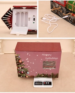 Detailed view of Christmas train decor showing USB port, battery compartment and packaging