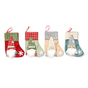 Set of four linen Christmas stockings with 3D gnomes and festive HO HO HO text design