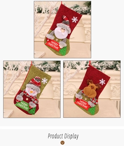 Close-up of three burlap Christmas stockings with 3D Santa, Snowman and Reindeer applique