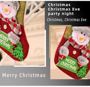 Detail of red knit Christmas stocking with snowman decor and Merry Christmas sign
