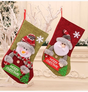 Detail of burlap Christmas stockings with 3D Santa and snowman felt appliques