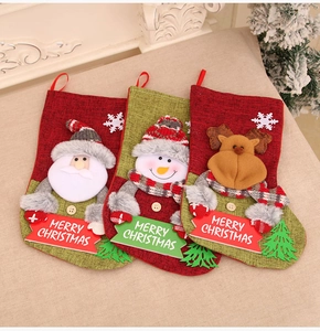 Detailed view of Christmas stockings with Santa, snowman and reindeer on plush blanket