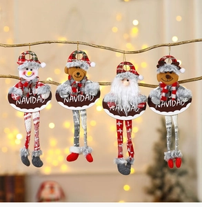 Detail of four fabric Christmas plush ornaments with long legs and Navidad signs