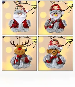 Detailed view of four plush Christmas ornaments including Santa and Snowman on tree