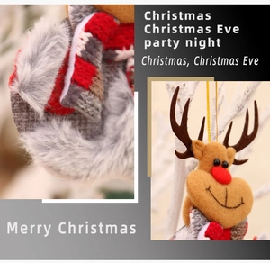 Detail of Christmas reindeer plush ornament with red scarf on a festive white branch