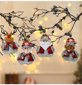 Set of four plush Christmas ornaments including elk and Santa on a winter branch