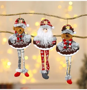 Plush Christmas ornaments with reindeer and Santa on branches with bokeh lights