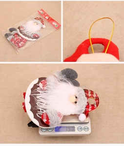 Detail view of Navidad Christmas gnome ornament with hanging rope and product weight scale