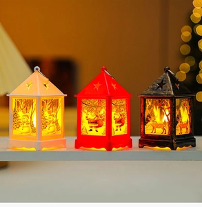 Close-up of LED Christmas lanterns with snowman and Santa patterns and warm light