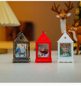 Three mini Christmas lanterns in bronze, red, and white with festive holiday illustrations