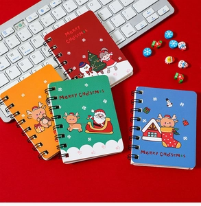 Set of four A7 Christmas spiral notebooks with colorful cartoon holiday illustrations