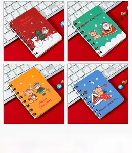 Close-up of four A7 mini Christmas spiral notebooks with cute festive cartoon covers