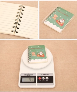 Detail view of A7 Christmas spiral notebook with Santa cover, inner pages and 47g weight