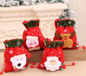 Detail of four festive Christmas drawstring bags with 3D plush holiday characters