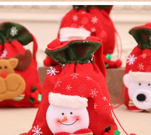 Close-up of festive Christmas drawstring gift bags with snowman and reindeer characters