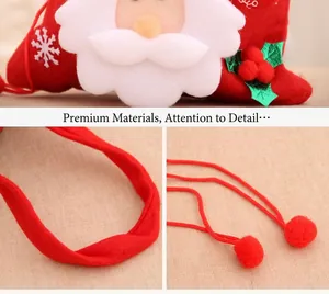 Detail of red Christmas felt gift bag featuring Santa Claus, snowflake and drawstring