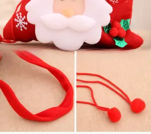 Detail of red Christmas felt gift bag featuring Santa Claus, snowflake and drawstring