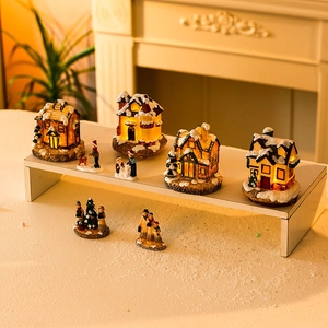 Illuminated Christmas resin village set with snowy houses and miniature figurines