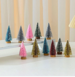 Miniature bottle brush Christmas trees with faux snow and wooden bases on display