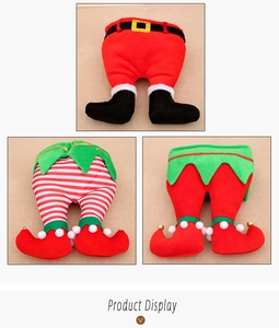 Detailed view of plush Christmas elf leg decorations in festive red and green colors