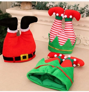 Detailed view of Christmas elf hats featuring striped legs, gold bells and plush textures