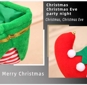 Detail of green velvet Christmas elf gift bag with gold ribbon and striped leg design