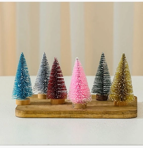 Close-up of colorful 10cm mini cedar Christmas trees with glitter on wooden bases