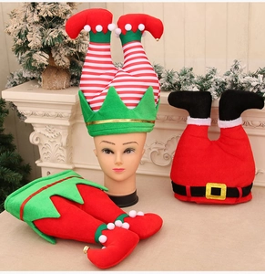 Funny Christmas elf and Santa Claus legs hats displayed on a model head in festive decor