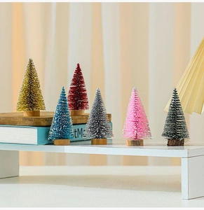 Macro detail of colorful mini cedar trees with snow frost effect and wooden bases
