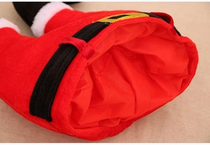 Detailed view of red plush Christmas pants decoration with belt and faux fur trim