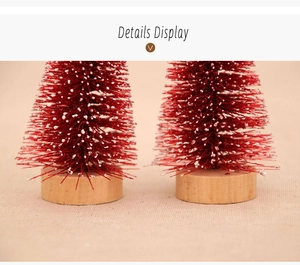 Detail of mini cedar Christmas tree with red needles, white snow tips and wooden base