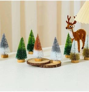 Miniature colorful glitter cedar Christmas trees with wooden bases on a festive table