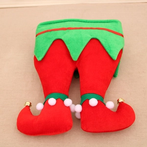 Detailed view of red and green elf leg decorations with plush balls and golden bells