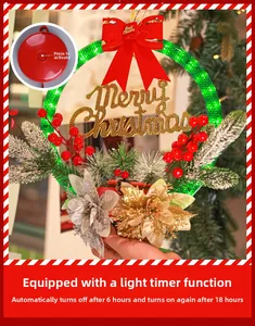 Detail of Christmas wreath with LED lights, pine needles, red berries and timer switch