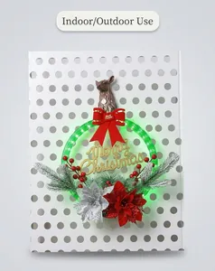 Close-up of lighted Christmas wreath with red bow, pine needles and Merry Christmas sign