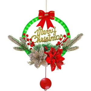 Illuminated Christmas wreath with Merry Christmas sign, red berries, and pine needles