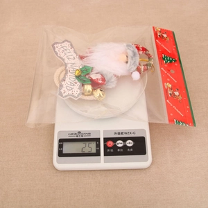 Detail showing Santa Claus ornament weight of 25g on a scale for Christmas decoration