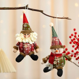 Plaid fabric Santa and Snowman Christmas ball ornaments hanging on a festive tree branch