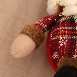 Macro detail of plaid Christmas ornament fabric with white snowflake pattern and plush texture