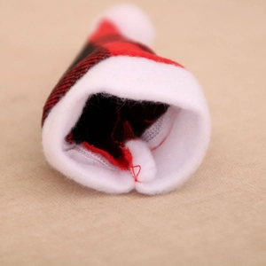 Detail shot of red plaid Christmas cutlery hat with white faux fur trim and red lining